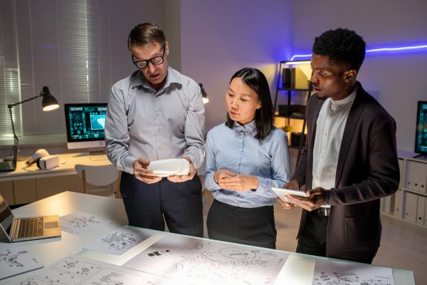 Chief Engineer Telling Concept of New Car Model Chief engineer showing 3D model to young multi-ethnic designers and telling concept of new car model in office